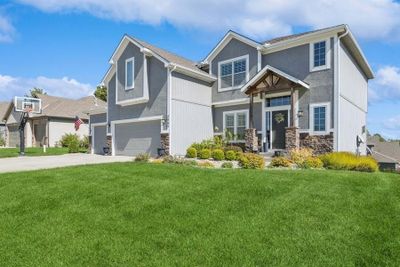 View of front of house featuring a garage and a front yard | Image 2