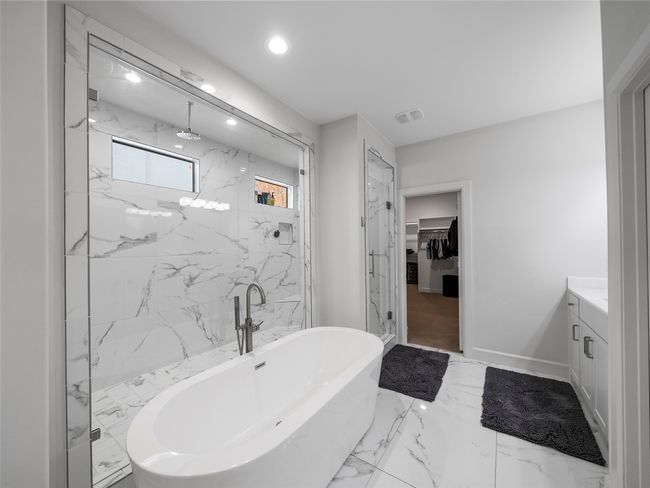 Full bath with a freestanding bath, vanity, marble finish floors, a marble finish shower, and recessed lighting | Image 4