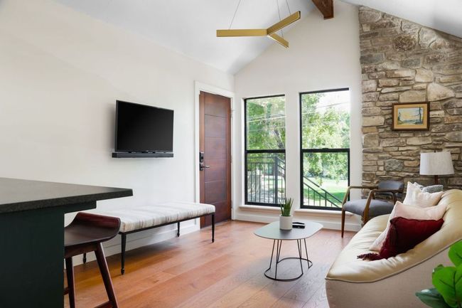 Living room with beamed ceiling, high vaulted ceiling, and wood finished floors | Image 20