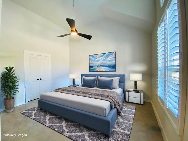 Primary bedroom with vaulted ceilings and fan. | Image 9