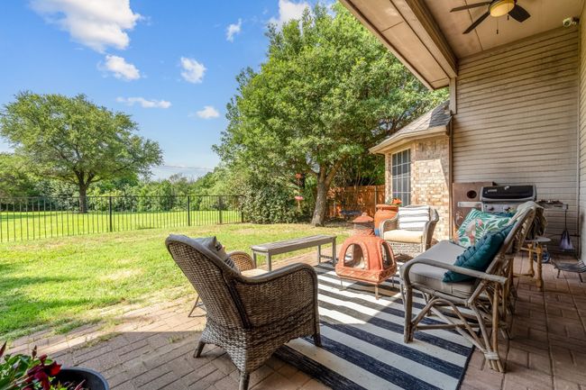 Wooden terrace with a ceiling fan and a patio area | Image 33