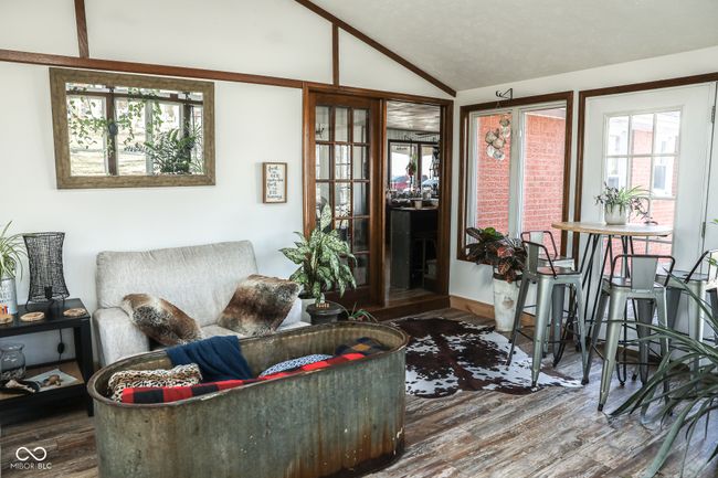 living room featuring wood finished floors and vaulted ceiling | Image 33