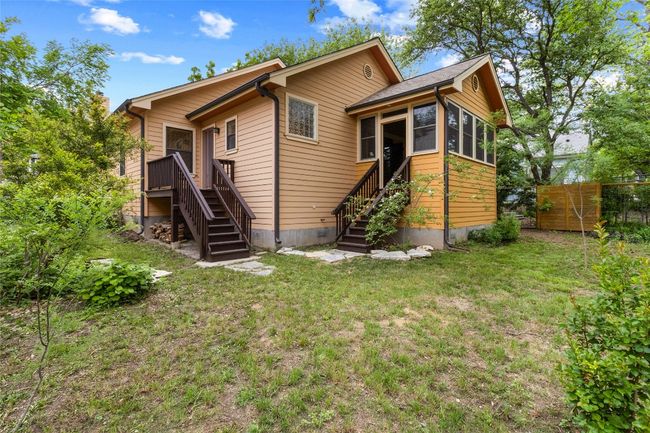 Rear view of house featuring a lawn, stairway, and fence | Image 26