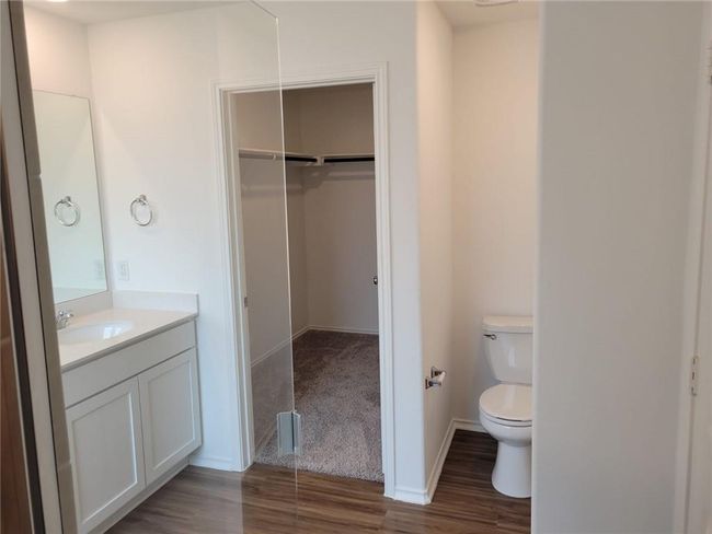 Bathroom featuring wood finished floors, vanity, and a spacious closet | Image 30