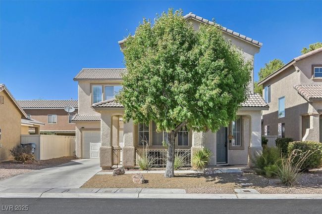 Mediterranean / spanish house with a garage, stucco siding, driveway, and a tile roof | Image 29