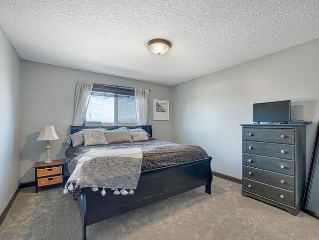 The third additional bedroom on the upper level is large enough for a king bed in addition to large furniture pieces. | Image 24