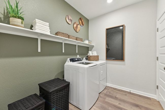 Laundry area featuring separate washer and dryer, light wood-style floors, baseboards, and recessed lighting | Image 16
