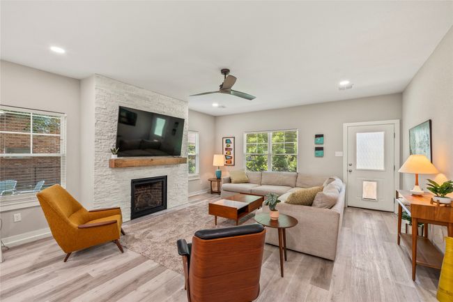 Large windows fill the living area with natural light. | Image 4