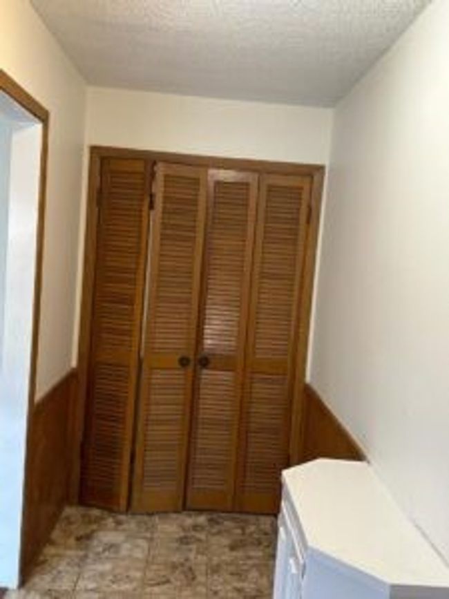 Corridor featuring a textured ceiling | Image 14