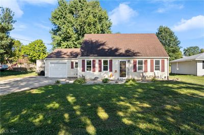 Cape cod home with a garage and a front yard | Image 1