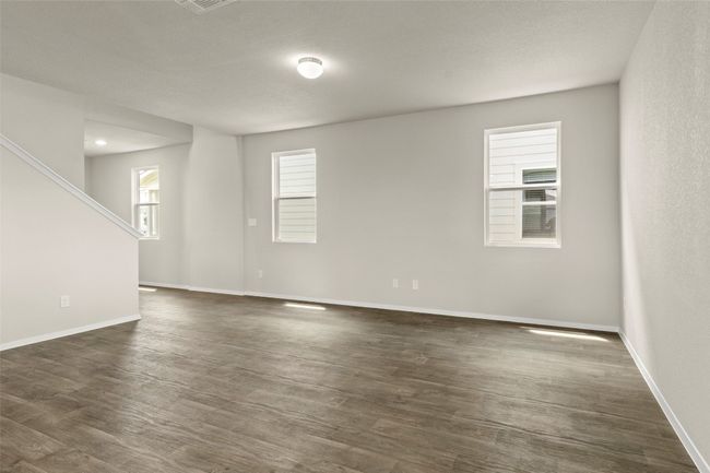 Spare room with dark wood-type flooring and stairway | Image 11