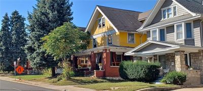 It's the yellow house. Driveway is on the near side. | Image 2