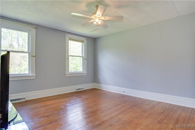 #2 with a ceiling fan, light wood-style floors, visible vents & large windows | Image 18
