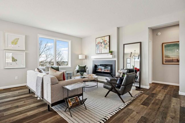 Open floor plan! Beautiful Gathering Room w/fireplace, & hallway to main floor bedrm! *Photos are of like home & may not depict actual home plan. Configurations, features, materials & finishes may contain options that are not included in the price.* | Image 5