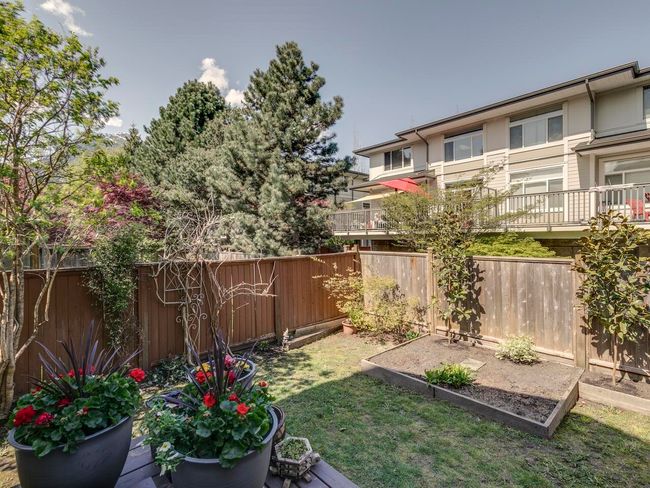 View of yard featuring a fenced backyard and a vegetable garden | Image 32