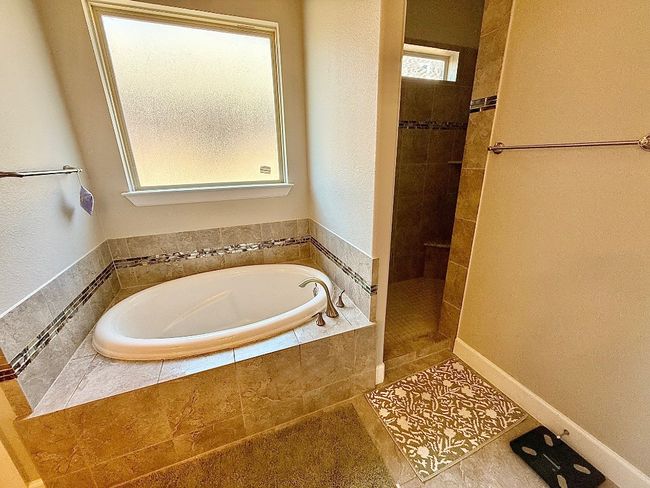Full bath with a garden tub, a tile shower, and tile patterned flooring | Image 11