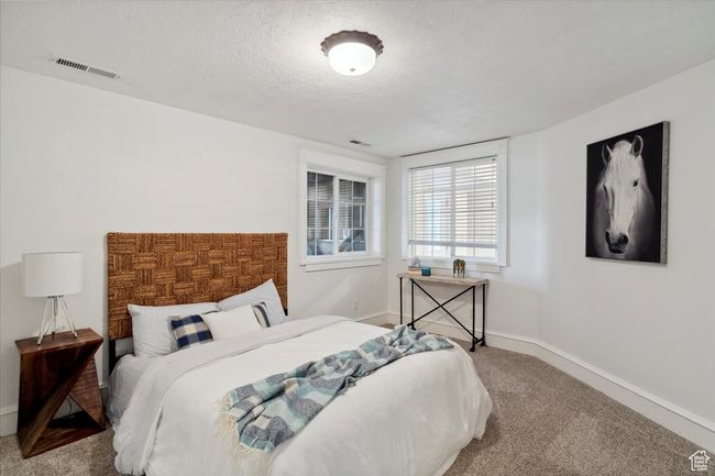 Carpeted bedroom with baseboards and a textured ceiling | Image 23