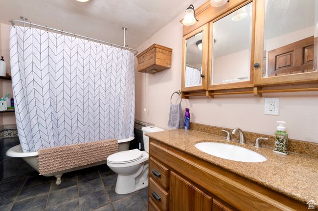 Full bath featuring toilet, vanity, and shower / bath combination with curtain | Image 20