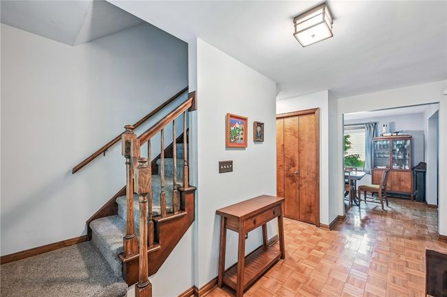 Bright entryway leading to the dining area and staircase. | Image 26