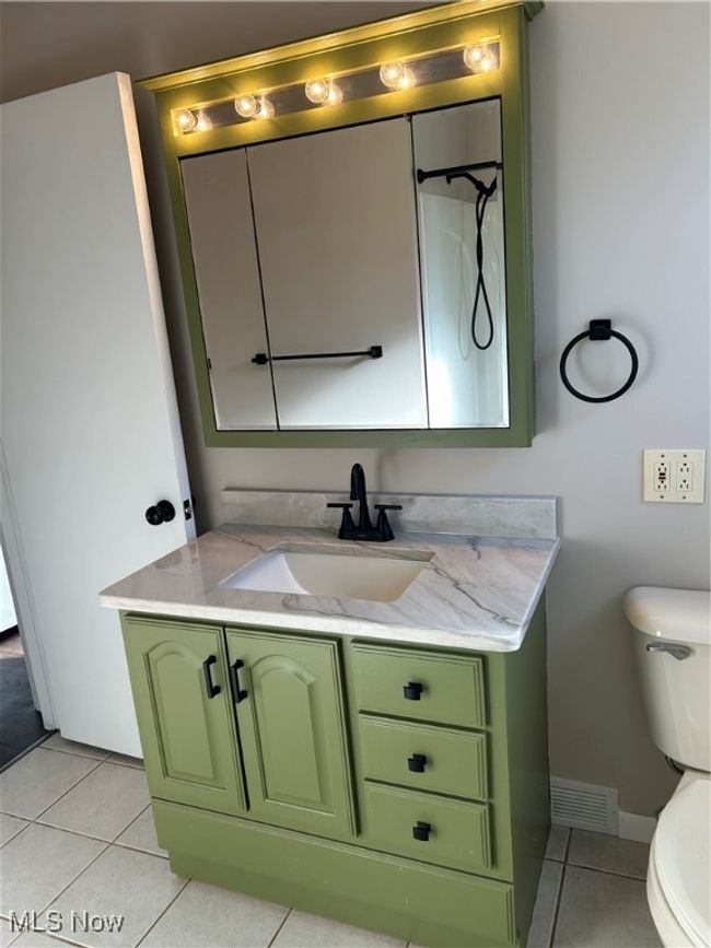 Bathroom with tile patterned floors, toilet, and vanity | Image 15