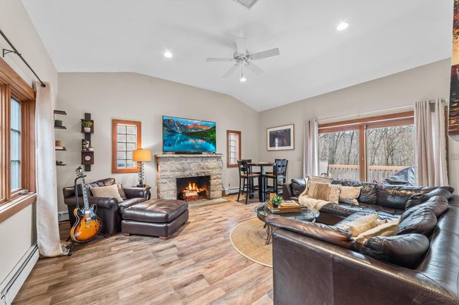 Family room with vaulted ceiling, wood-style floors, and a ceiling fan | Image 19