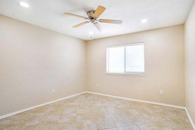 Spare room featuring light tile patterned flooring, baseboards, a ceiling fan, and recessed lighting | Image 9