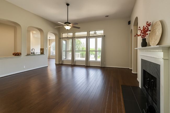 Large Family room with fireplace, wood flooring, looking over back patio. | Image 6
