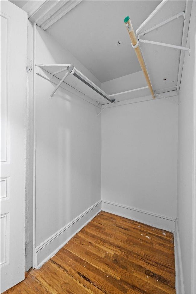 Walk in closet with wood finished floors | Image 7