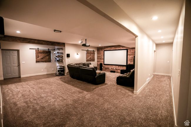 Carpeted cinema with a barn door, recessed lighting, and baseboards | Image 59