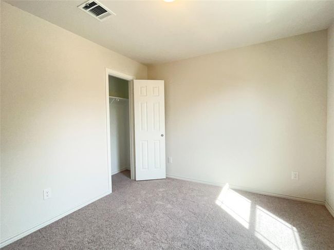 Cozy upstairs second bedroom with plush carpeting. | Image 12