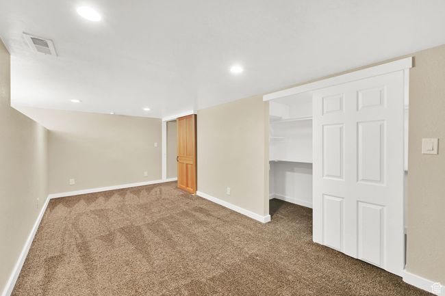 Finished below grade area with baseboards, carpet flooring, visible vents, and recessed lighting | Image 22