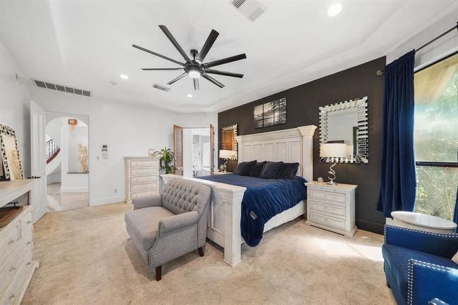 A glass door offers private access to the covered patio & backyard. This is a view of the owner's bedroom from the sitting area. | Image 20