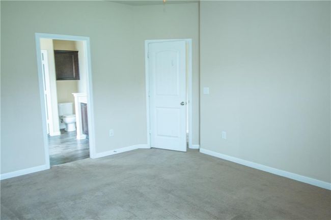 Unfurnished bedroom featuring carpet flooring and ensuite bathroom | Image 6