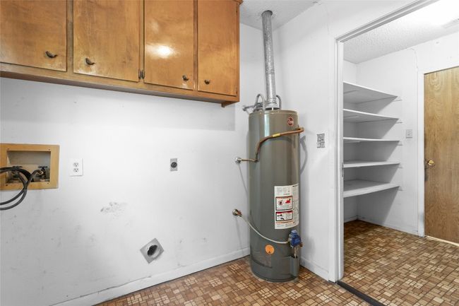 Utility room featuring gas water heater | Image 11