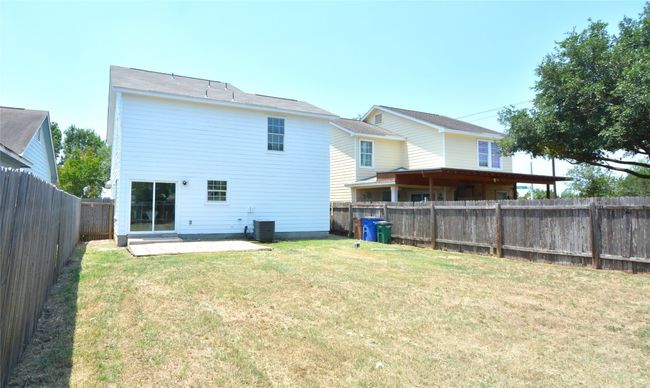 Rear view of house with a patio area and central air condition unit | Image 21