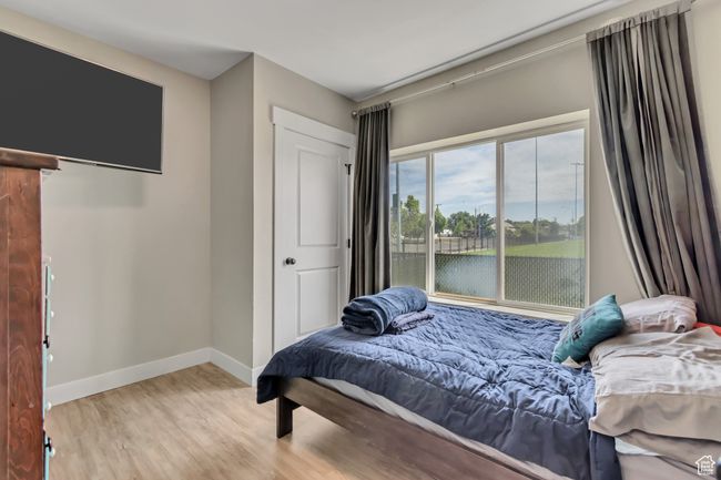 Bedroom with wood finished floors and baseboards | Image 10