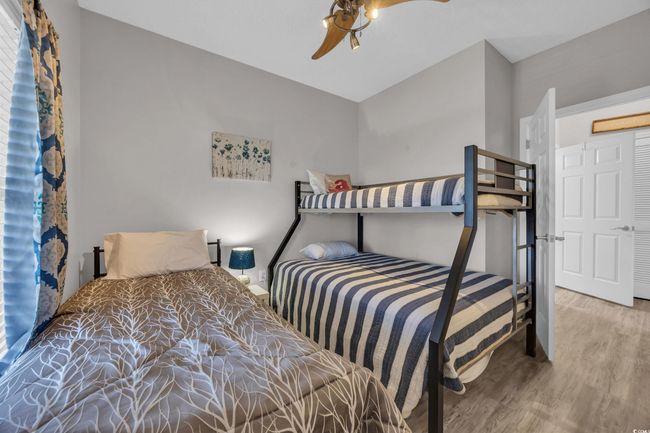 Bedroom with a ceiling fan and wood finished floors | Image 23