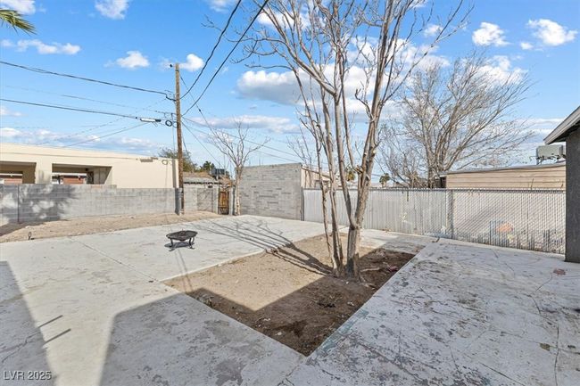 View of yard featuring a patio, an outdoor fire pit, and a fenced backyard | Image 24
