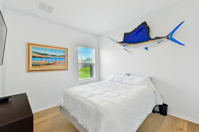 Bedroom with wood finished floors and baseboards | Image 18