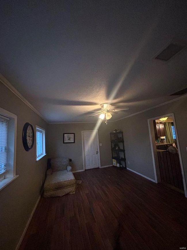 Unfurnished bedroom featuring ceiling fan, wood finished floors, baseboards, and ornamental molding | Image 7