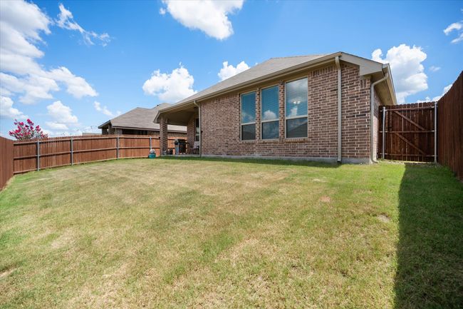 Back of house featuring brick siding and a fenced backyard | Image 28