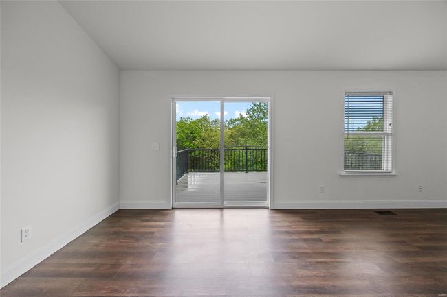 Empty room featuring baseboards, wood finished floors, and visible vents | Image 32