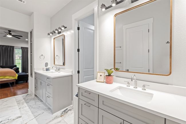 Bathroom featuring ceiling fan, two vanities, connected bathroom, and marble finish floors | Image 17