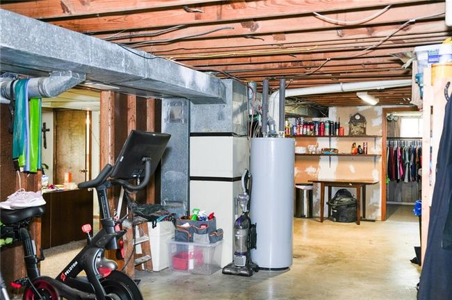 Unfinished below grade area featuring water heater | Image 21