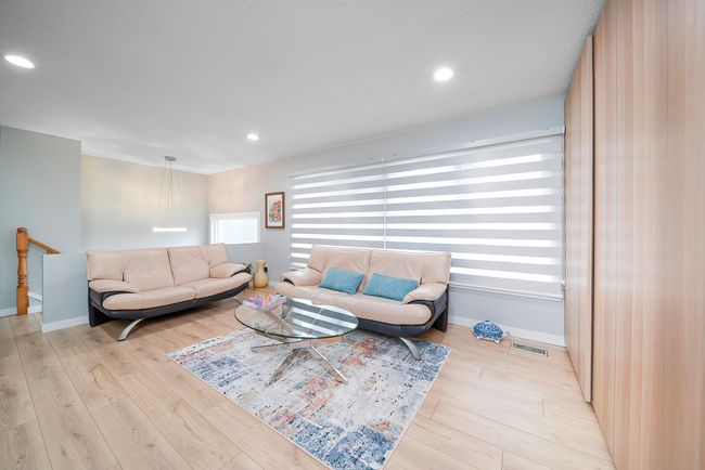 Living room featuring baseboards, visible vents, wood finished floors, and recessed lighting | Image 10