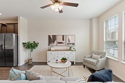 Living room featuring ceiling fan, a healthy amount of sunlight, and dark hardwood / wood-style floors | Image 1