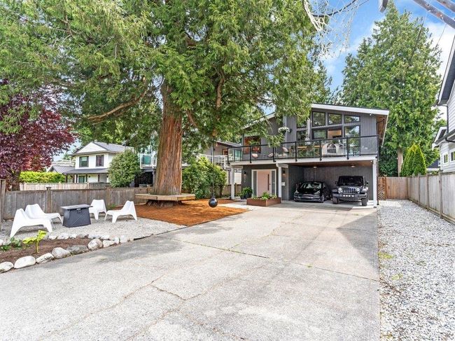 Front of house features balcony, modern new door, new windows, a breathtaking tree w seating + a wrecking ball for the kids to swing on, a fire table area, garden box, a basketball hoop, & 6 parking incl. a 2 car carport. B.G School is at end of the block! | Image 4