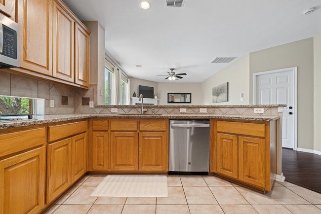 Surrounded by open sightlines to the living and dining areas, the kitchen offers a seamless connection to the rest of the home—easy, effortless, and always part of the action | Image 14