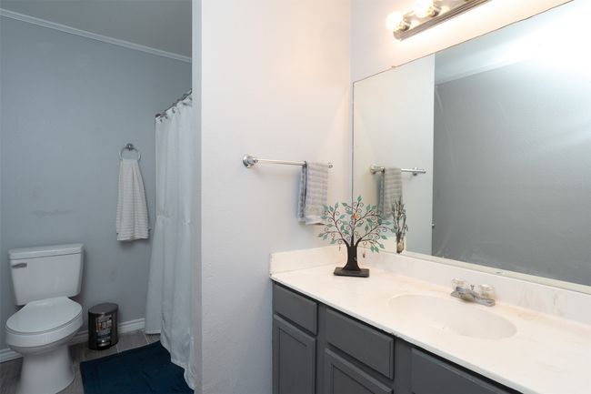 Full bath featuring vanity, toilet, and ornamental molding | Image 20