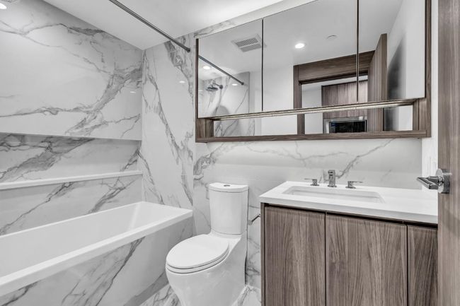 Bathroom with vanity, marble finish flooring, tile walls, and a combined bath / shower with marble appearance | Image 19